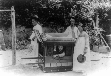 Korean noble boy carried by servants in a sedan chair 1900