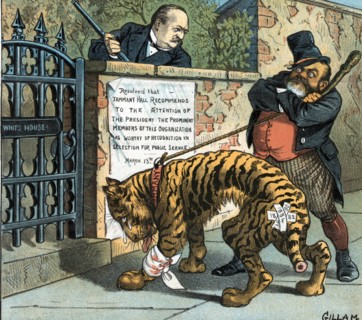 John Kelly holding a shillelagh in one hand and a rope tied to an injured tiger