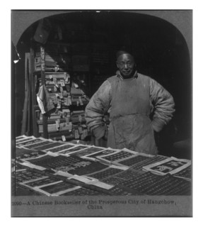 Photograph of a Chinese bookseller of the prosperous City of Hangchow, China.