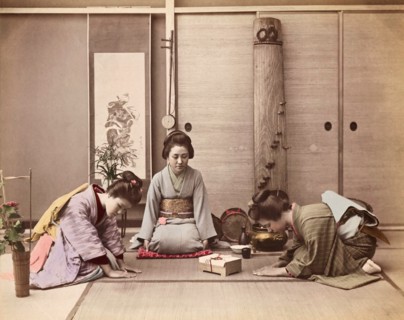 Colour Photograph of two Japanese women greeting another woman with a gift box tied with mizuhiki