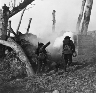 Photograph of American soldiers advancing on a German bunker position