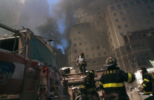Colour photograph of a New York Fire-fighter amid the rubble of the World Trade Centre following the 9/11 attacks