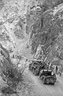 Photograph of a US Army Truck towing a Jeep during World War Two