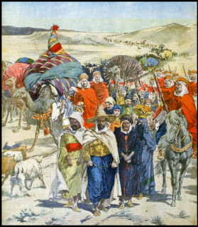 A Razzia or slave raid in caravan formation passing through the Algerian Sahara desert, 1900