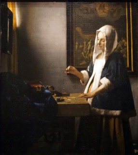 Painting titled 'Woman Holding a Balance' by Johannes Vermeer