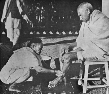 Mahatma Gandhi having his feet washed, by his wife Kasturba, at Sevagram a village in the state of Maharashtra, India