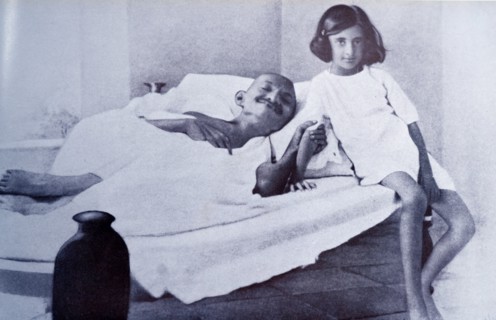 Mahatma Gandhi during a hunger strike is accompanied by Indira