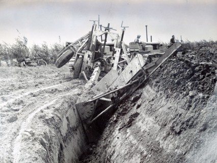 Photograph of a Dutch farmer construction a polder from land reclaimed for the sea bed