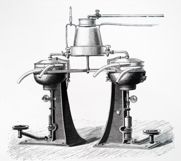 A twin centrifugal cream separators with milk warmer mounted above them