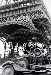 World War Two: German soldiers sit in a vehicle under the Eiffel Tower as they occupy Paris, during the invasion of France 1940
