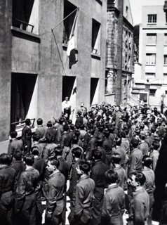 Photograph of young French workmen at a factory listen to news of the German invasion of France 1940