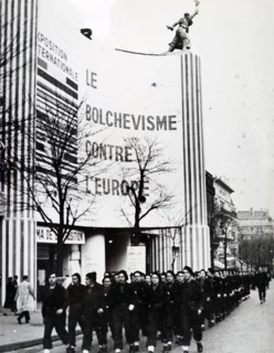 Photograph taken of a Pro-German march, past the Paris exhibition 'Bolshevlsme contra l'europe', during the German occupation of France, in World War Two