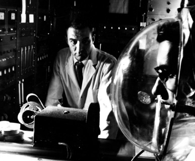 Photograph of a physicist monitoring a complex experiment using a closed respirometer