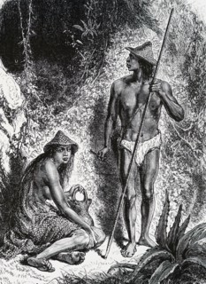 A Native American Indian using a blow-pipe for hunting animals