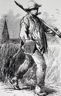 A French labourer walking with some tools