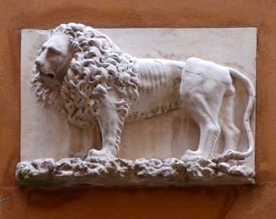 The Lion symbol of Venice, depicted on a wall relief, in the city