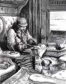A man in a first class carriage preparing to eat his lunch