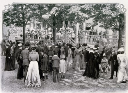 Photograph of a crowd watching a performance in La Rue de Paris entitled the Parade des Auteurs Gais.