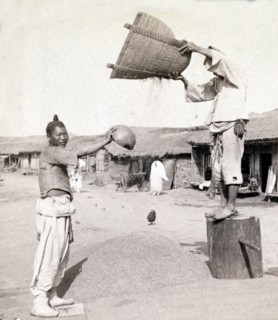 winnowing barley in the streets of Chemulop, Korea. Joseon Era