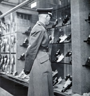 A German officer looks at the empty shops in Paris during World War II
