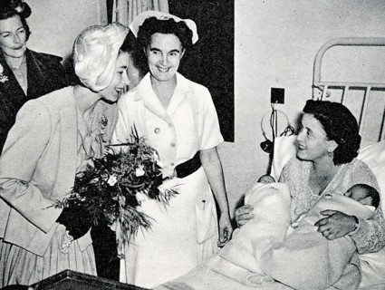 Admiring the twins of Mrs Harvey, wife of C.P.O. Harvey, of H.M.S. Chequers. Princess Elizabeth and Countess Mounbatten