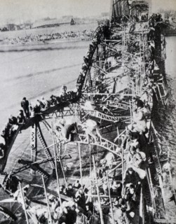 Korean War: Thousands of North Korean crossing a partly destroyed bridge on the Taedong River, fleeing Communist troops