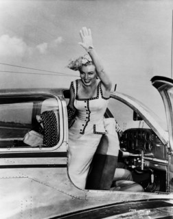 Marilyn Monroe, actress USA, waving out of an aeroplane. Around 1953