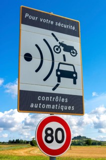 Sign of speed limit reduced to 80 km/hour and radar speed check