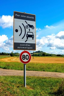 Sign of speed limit reduced to 80 km/hour and radar speed check