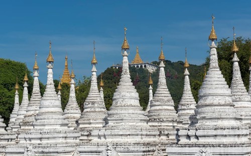 Row of white stupas at Sandamuni Pagoda
