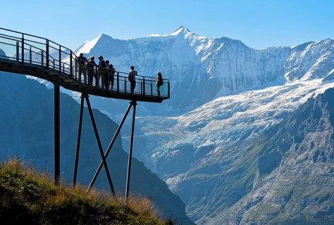 Tourists on the observation deck of the First Cliff Walk by Tissot in front of the Fiescherhorn north face and the Grindelwald glacier