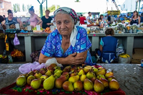 Woman selling apples on a local market