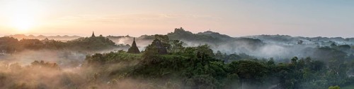 Mist over hills and stupas of Mrauk U at sunrise