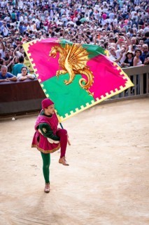 Man carrying a historical flag during the Corteo Storico parade before the Palio di Siena horse race