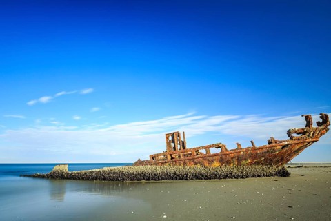 Rusty shipwreck on the beach