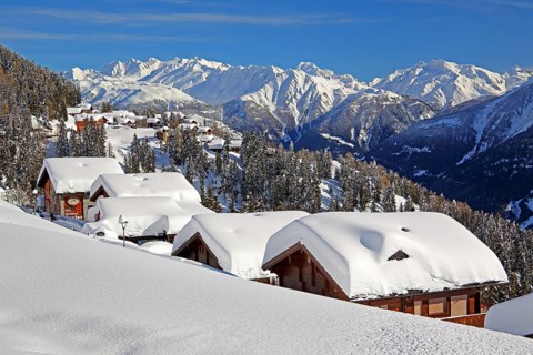 Winter landscape with snow-covered chalets