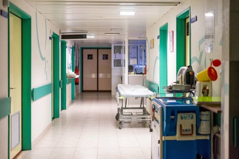Hospital corridor with a bed waiting for the next patient