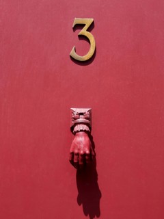 Doorknocker on a red door