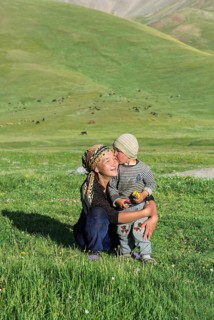 Kyrgyz boy kissing his mother