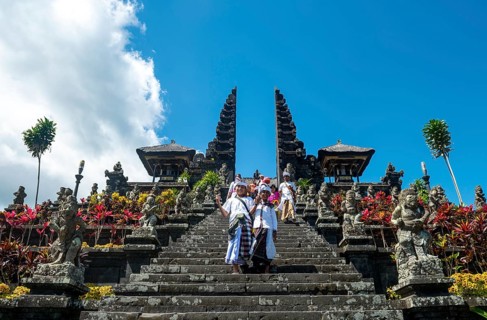 Two Balinese boys go down stairs