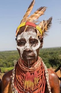 Woman with face painting and feather decoration