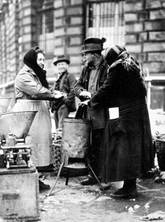 Humans warm themselves at wood stove approx. 1930