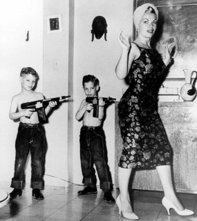 Two boys with rifles against mother
