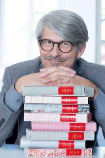 Man leaning on a book pile