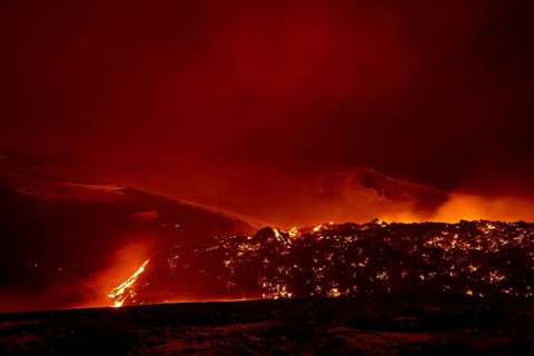 Glowing lava and lava flow at night at Fimmvorouhals volcano