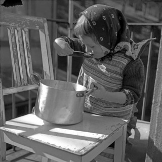 Child slurps out of a pot