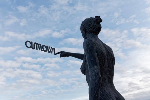 Woman writes French word Amour