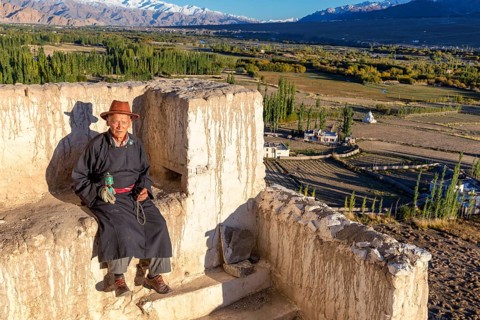 Elderly man taking a rest on a wall
