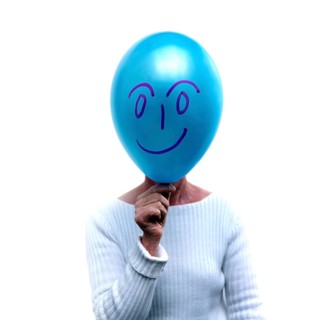 Woman with a blue balloon in front of her face