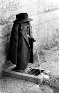 Tap as clothes rack for jacket and hat